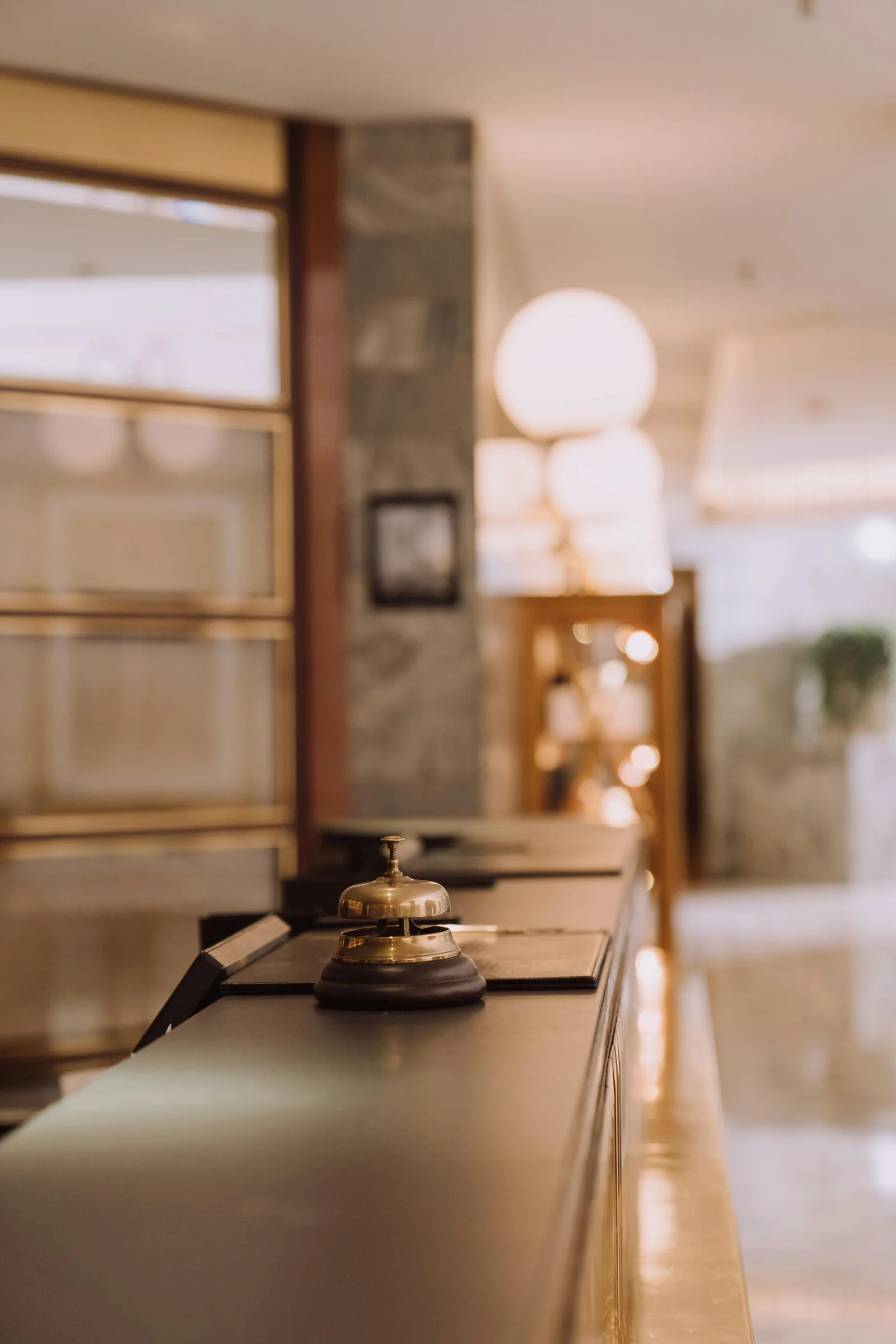 A brass bell on a hotel reception counter
